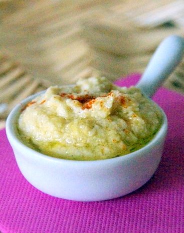 Houmous maison dans ramequin blanc sur serviette rose