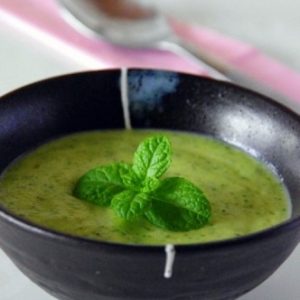 Soupe froide verte à la menthe dans un bol noir.