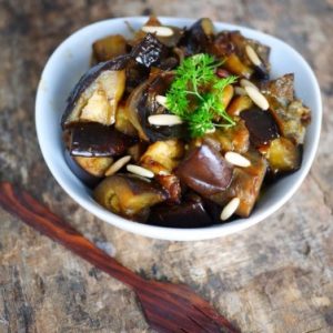 Aubergines confites aux pignons, plat méditerranéen savoureux.