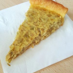 Part de tarte aux oignons sur serviette en papier.