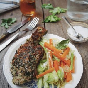 Plat de viande, carottes et céleri sur table bois.