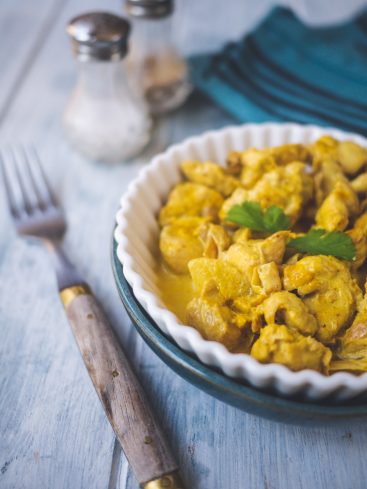 Poulet au curry servi dans un bol, fourchette.