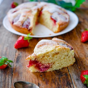 Gâteau aux fraises saupoudré de sucre glace sur bois.