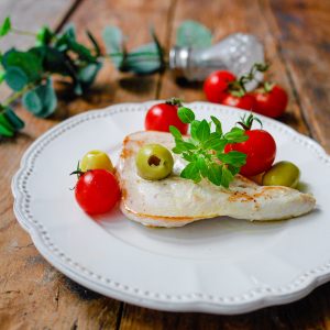 Plat de poulet, tomates cerises et olives vertes.