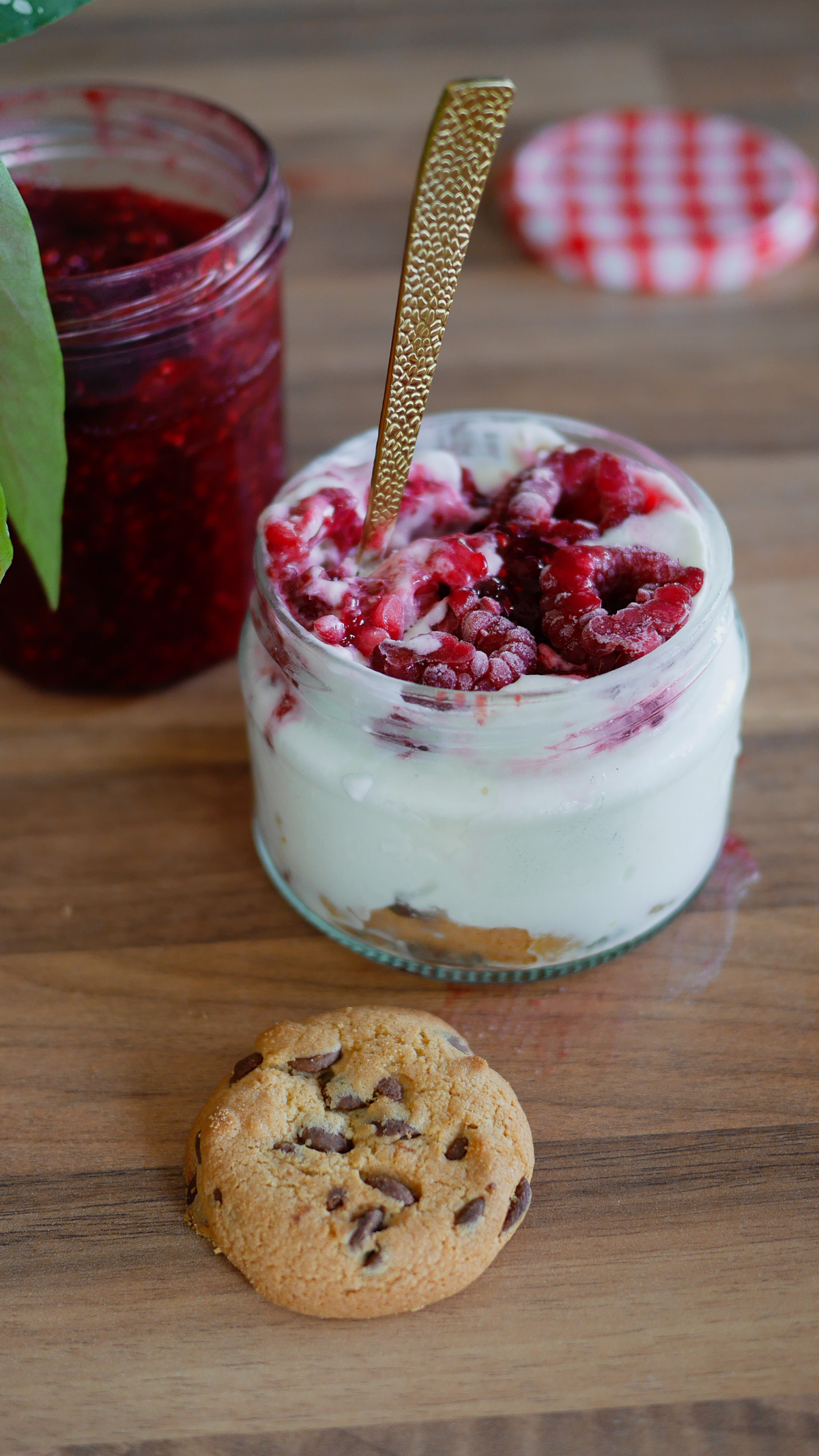 Dessert yaourt framboises, confiture et cookie sur bois